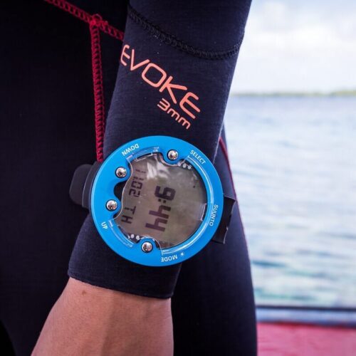 Dive computer on a scuba diver's wrist over a Bare Evoke wetsuit